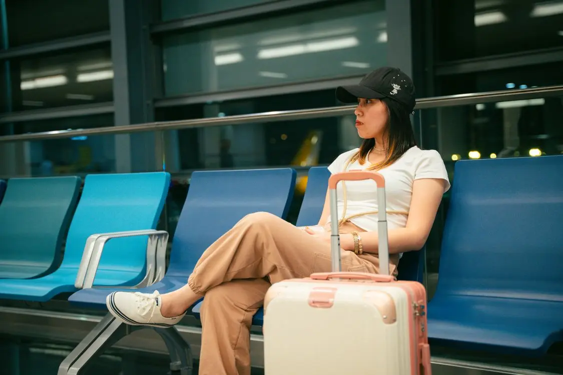 Airport traveller checking her phone on arrival